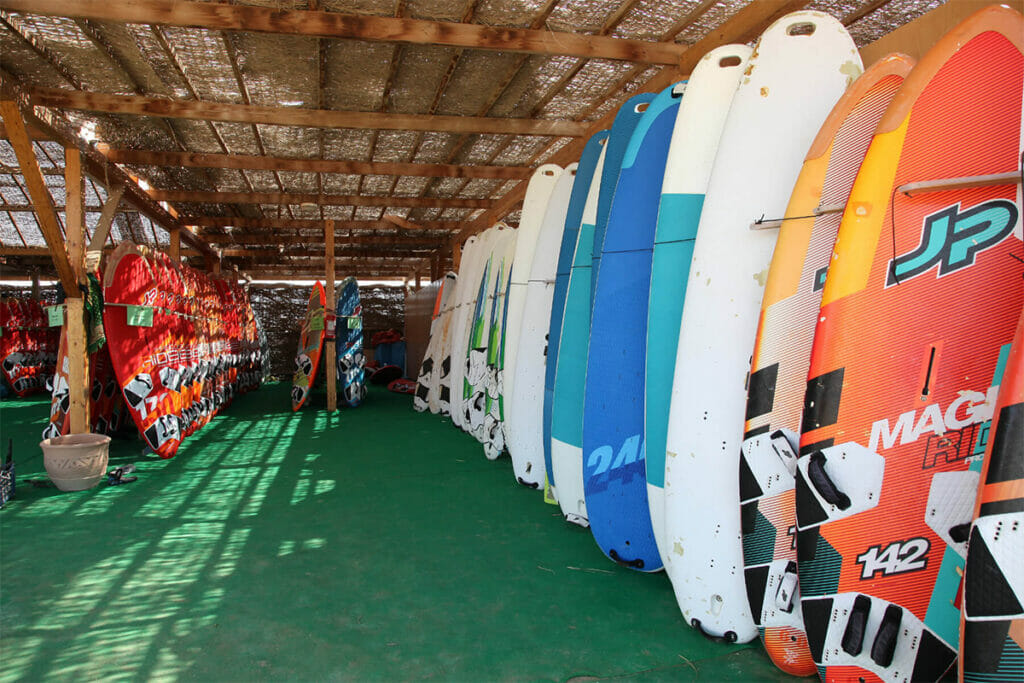 Surfboards piled up under a roof