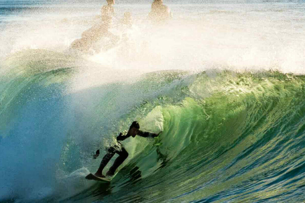 Surfer beim Reiten einer Welle in Portugal