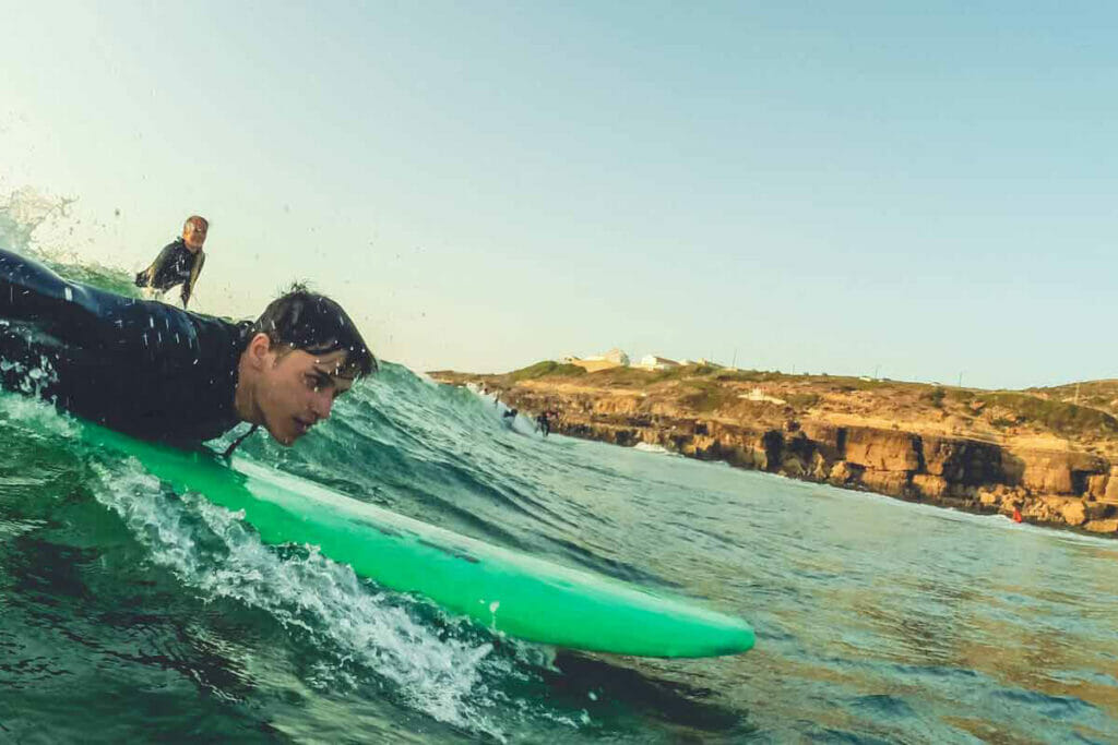 Surfer paddles in the sea of Portugal