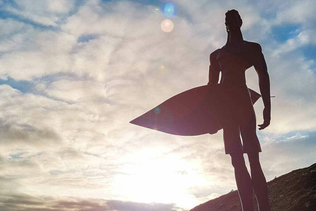 Statue surfer from below at surf camp Ericeira