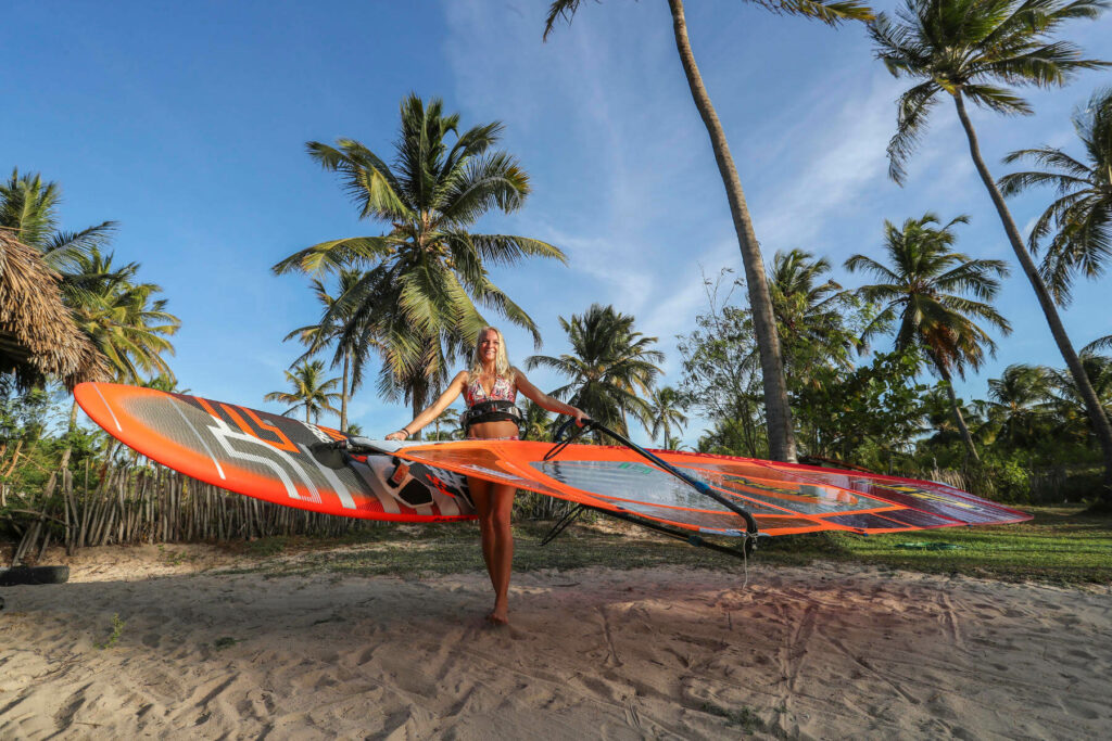 Windsurfer on beach with palm trees in Jericoacoara